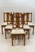 A set of six modern teak dining chairs with pierced splats,