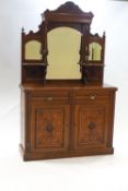 An Edwardian mahogany sideboard with raised mirror back above two short drawers and two cupboard
