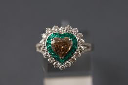An unusual 18ct white gold heart shaped ring set with a central champagne diamond of 1.22ct.