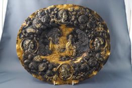 A 19th century continental gilt oval dish with repousse decoration,