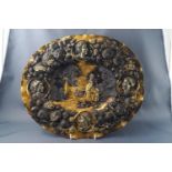 A 19th century continental gilt oval dish with repousse decoration,