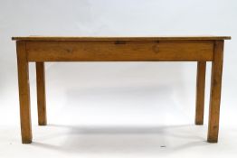 A Victorian pine kitchen table with plank top on square legs 76cm high x 152.