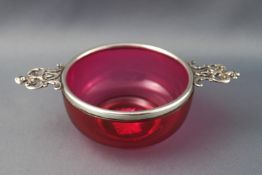 A cranberry glass and silver mounted quaiche, by William Comyns & Sons Ltd, 18cm diameter,