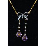 A yellow and white metal centrepiece necklace stylized as a drop bow and set with amethyst,