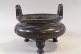 A Chinese bronze incense burner decorated all over with dragons with seal mark and three spur feet,