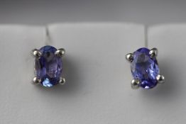 A white metal pair of single stone tanzanite stud earrings approximate 1.20ct total.