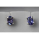 A white metal pair of single stone tanzanite stud earrings approximate 1.20ct total.