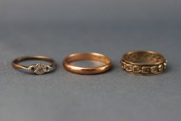 A selection of three rings - eternity, three stone and a wedding band. Sizes N to S.