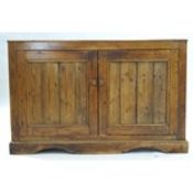 A Victorian pine dresser base, the panelled doors enclosing one shelf,