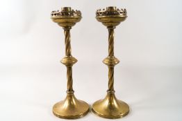 A pair of Victorian brass candlesticks in the Gothic style,