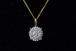 A yellow and white metal diamond cluster pendant set with eleven round brilliant cut diamonds.
