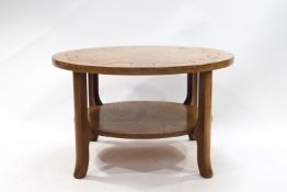 A mid 20th century teak round coffee table, the four legs linked by an undertier, 51m high,