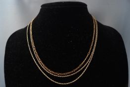 A 9ct gold chain and two silver gilt necklaces. Gross weight: 6.
