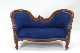 A Victorian style child's mahogany show frame two seat sofa on cabriole legs,