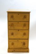 A pine chest of four drawers, with turned handles on plinth base 117cm high, 61cm wide,