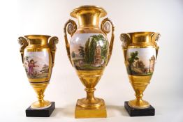 A composite garniture of three early 19th century Paris porcelain vases,