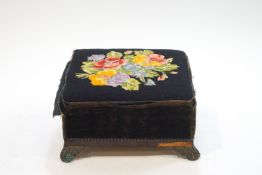 A Victorian footstool with tapestry top and brass scroll feet,