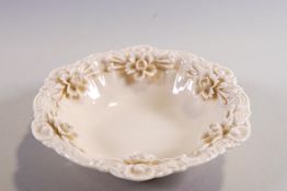 A Belleek style porcelain bowl with applied flower decoration,