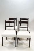 A set of four Regency style mahogany chairs with rope twist backs on front sabre legs