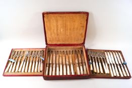 An early 19th century silver part set of dessert knives and forks with mother of pearl handles in