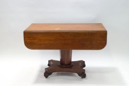 A William IV mahogany Pembroke table, with octagonal pedestal on wasted rectangular base, 72cm high,