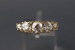 A yellow metal five stone carved half hoop ring set with rose cut diamond pointers.