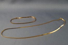 A yellow metal flat snake link necklace and bracelet set, stamped 375 for 9ct gold. Gross weight 3.