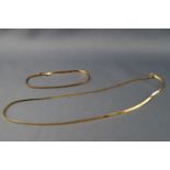 A yellow metal flat snake link necklace and bracelet set, stamped 375 for 9ct gold. Gross weight 3.
