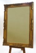 A Victorian gilt picture frame with later mirror glass, label verso for Ailken Dottdon,