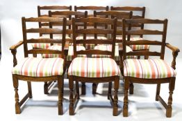 A set of eight oak ladderback dining chairs on turned and block legs with striped upholstered seats