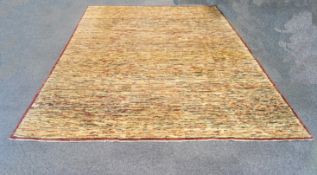 A large 20th century carpet with multi colours on a cream ground within a thin border,