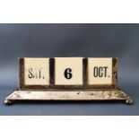 A silver mounted desk calendar, with flared base on four ball feet, with ivorine inserts,