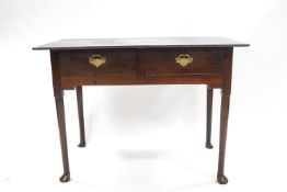 An 18th century oak side table with two drawers, on slender legs with pad feet,