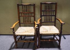 A pair of 19th century turned elm and beech rush seated elbow chairs,