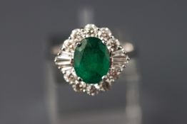 A white metal emerald and diamond cluster ring. Emerald weight approx 1.97ct.