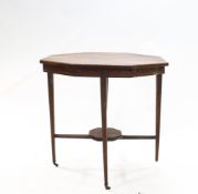 An Edwardian mahogany octagonal table with tapered legs on brass casters with under tier, 74.