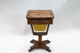 A William IV rosewood work table with chess board top on wasted rectangular base and scroll legs,
