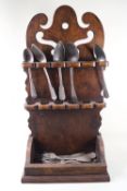 An elm spoon rack in 18th century style with various spoons and forks,