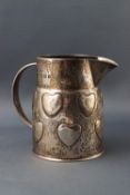 A Liberty and Co. silver milk jug, embossed with hearts, 7.
