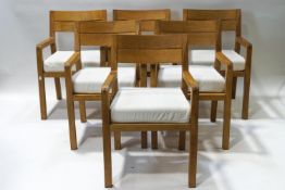 A Heals oak dining table and a set of six matching chairs with white upholstered cushions,