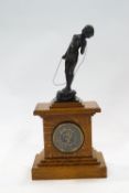 A Victorian oak cased mantel clock with bronze patinated plaster figure finial in the form of a