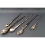 Five silver button hooks, of various designs and sizes, the largest being 28.