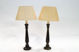 A pair of black and gilt painted turned wood table lamps, 57.