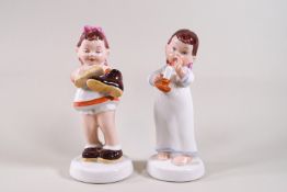 A pair of Royal Dux porcelain figures of children,