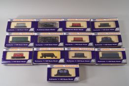 Thirteen Dapol N-gauge model railway coaches, wagons and two locomotives,