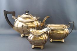 A silver three piece tea set, of boat form on four ball feet, by John Round & Son Ltd,