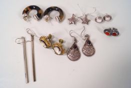 Seven pairs of silver earrings