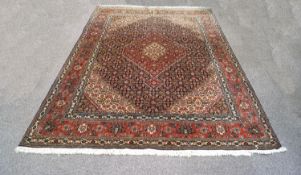 A 20th century rug with central medallion on a blue field within multiple borders,