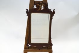 An early 19th century carved fretwork wall mirror with Ho-Ho bird,