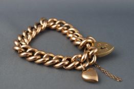 A yellow metal hollow curb link bracelet with padlock clasp and safety chain.